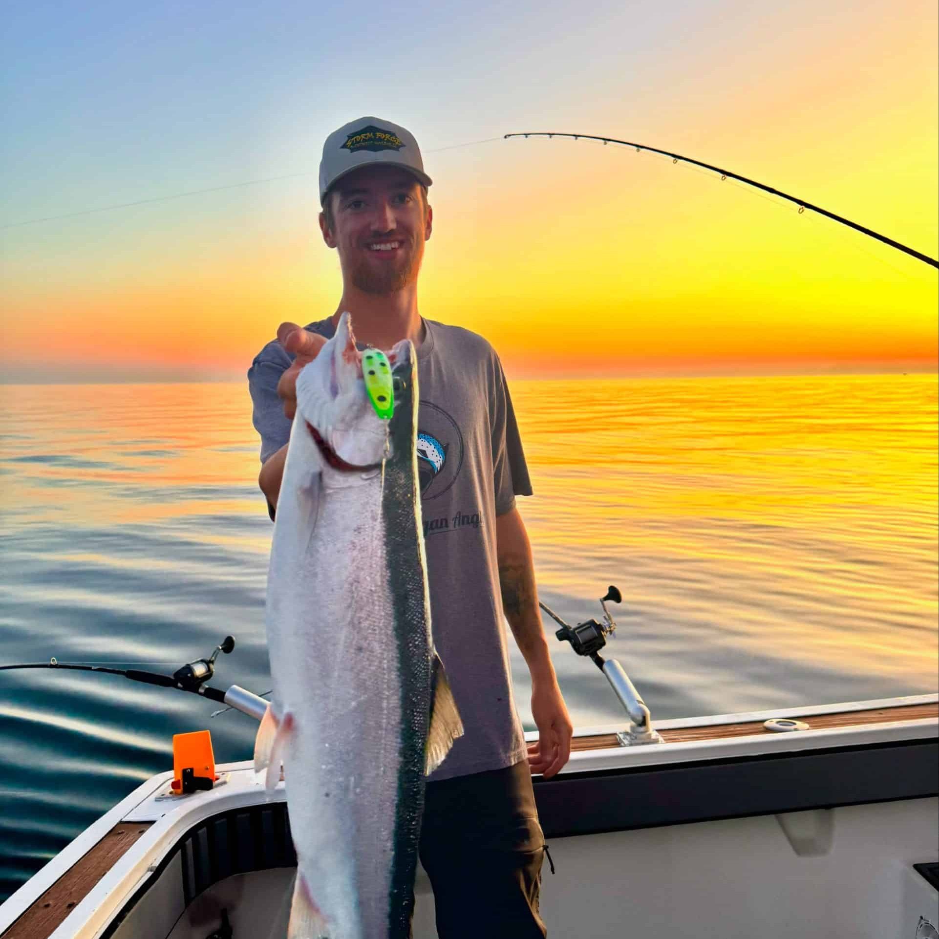 Captain Blake with a large fish on Storm Force fishing charter on Lake Michigan